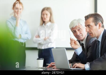 Business people working with laptop together in office Stockfoto