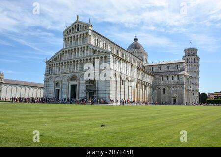 PISA, ITALIEN - 14. August 2019: Die Kathedrale von Pisa in der Nähe des Schiefen Turms von Pisa mit vielen Touristen an einem sonnigen Tag Stockfoto