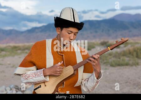 Musiker, der lokales traditionelles Instrument spielt, in Issyk Kul, Kirgisistan Stockfoto