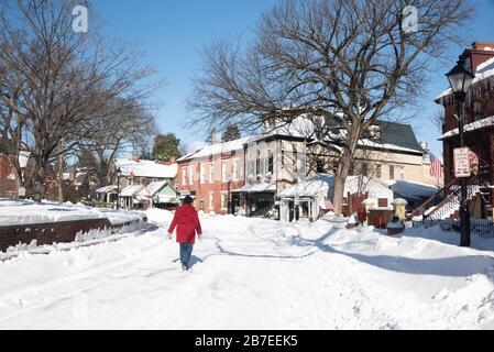 Annapolis Street Szene am sonnigen Tag nach blizzard mit Schnee auf Straßen und Gehwegen, entfernter Fußgänger zu Fuß in der verschneiten Straße. Stockfoto