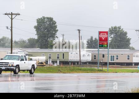 Chetopa, USA - 15. Oktober 2019: Verregnete Straße in der Kleinstadt in Kansas auf dem Land mit rotem Conoco-Tankstellenschild Stockfoto