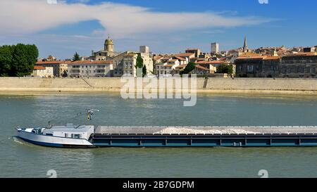 Barge auf der rhone und Arles auf dem Hintergrund, eine Stadt und Gemeinde im Süden Frankreichs Stockfoto