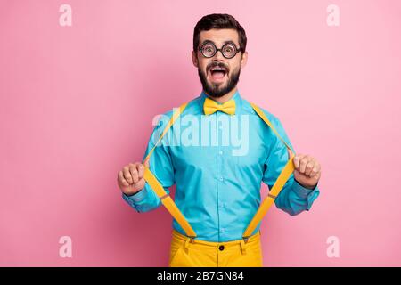 Porträt seines hübschen, trendigen komischen fröhlichen fröhlichen bärtigen Kerls nerd mit dünnen Spätzchen Minzemhirt ziehen Hosenträger Spaß haben Stockfoto