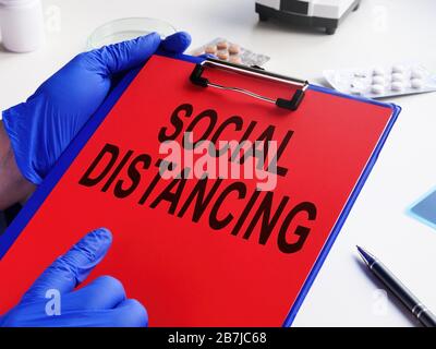 Doktor hält Verordnungsoziale Distanzierung mit Coronavirus Kovid-19. Stockfoto