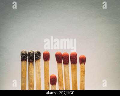 Matchstäbchen brennen, ein Stück verhindert die Brandausbreitung - das Konzept, wie man das Coronavirus davon abhält, sich zu verbreiten: Isolation, zu Hause zu bleiben und Stockfoto