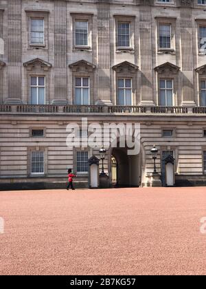 London, Großbritannien - 12. Mai 2019: Sentry of the Grenadier Guards an einem sonnigen Tag vor dem Buckingham Palace postiert Stockfoto