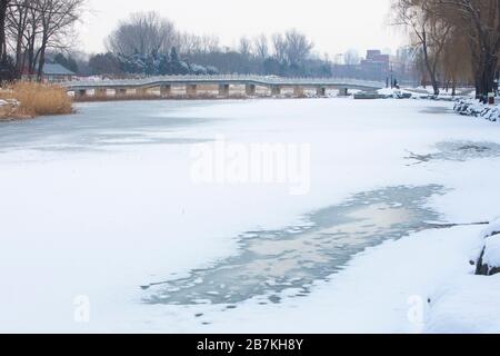 Der Schnee bedeckt Architekturen, Wälder und Straßen im alten Sommerpalast, der auf Chinesisch als Yuanming Yuan bekannt ist und eine malerische weiße Welt bildet, Beijin Stockfoto