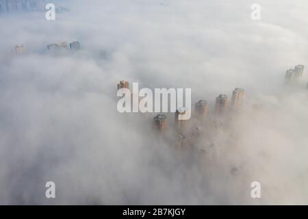 Wolkenkratzer sind vom Nebel in der Stadt Huaibei, der ostchinesischen Provinz Anhui, am 12. Februar 2020, umgeben. Stockfoto