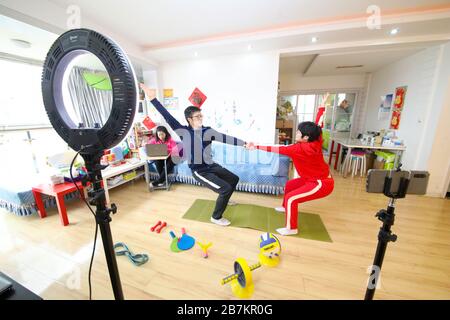 Ein Sportlehrer, schwarz, quetscht mit einer Person vor einem Aufnahmegerät zu Hause in der Stadt Huai'an, der Provinz Jiangsu im Osten Chinas, am 25. Februar 2020. Stockfoto