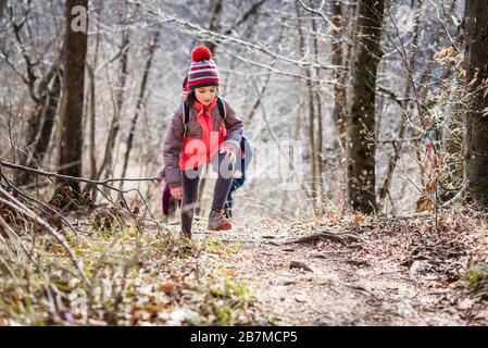 Familienporträt auf Waldreise mit Wanderkleidung. Winterporträt der Familie auf Familienwanderung in Wald, aktive Familie, Eltern und Kinder Stockfoto