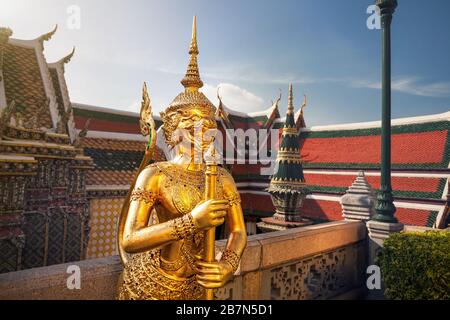 Goldene Guardian-Statue im Tempel des Smaragd Buddha Wat Phra Kaew in Bangkok bei Sonnenuntergang Stockfoto