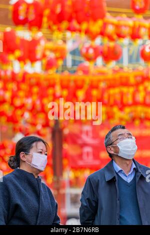London, Großbritannien. März 2020. Touristen und Einheimische verdecken sich, während sie die ruhigeren Straßen von China Town durchstreifen - Anti Coronavirus (Covid 19)-Verteidigung, die in London unangsam Masken trägt. Credit: Guy Bell/Alamy Live News Stockfoto