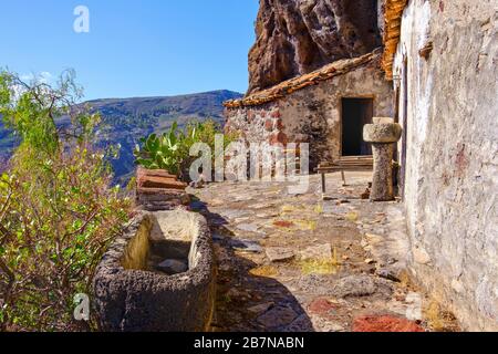 Verlassene Häuser unter Felswand, Tacalcuse, in der Nähe von San Sebastian, La Gomera, Kanarische Inseln, Spanien Stockfoto