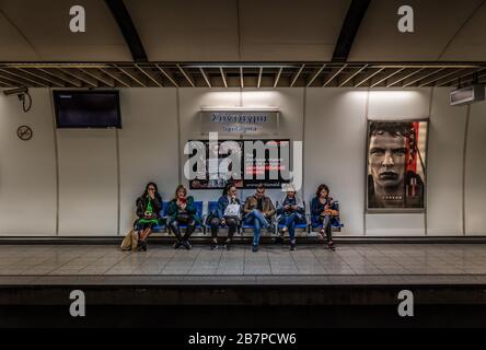 Athens, Attica / Greece - 12 26 2019: Reisende, die auf den Zug warten, stehen am Bahnsteig der Syntagma-U-Bahn Stockfoto