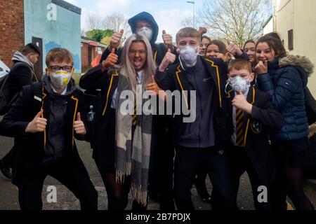 Schulkinder, die Gesichtsmasken tragen, machen sich am 17. März 2020 auf den Weg zur Park View School, Chester le Street, Durham, Großbritannien. Stockfoto