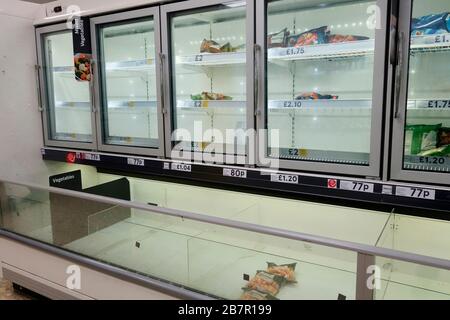 Leere Gefrierschränke in einem Tesco-Geschäft in Surrey, Großbritannien aufgrund von Panikkäufen wegen Coronavirus. März 2020 Stockfoto