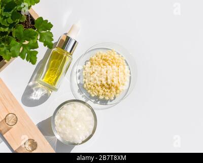 Gelbe Kosmetikfarbe (Öl), mikrokristallines Wachs und Candelilla Wax. Chemikalien für die Schönheitspflege in natürlicher Form in weißem Hintergrund. Stockfoto