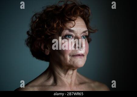 Frau am Fenster, die über das Leben nachdenkt Stockfoto