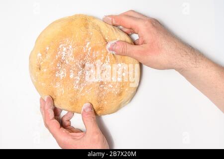 Frisch gebackenes Brot in Bäckerhand isoliert auf weißem Hintergrund Stockfoto