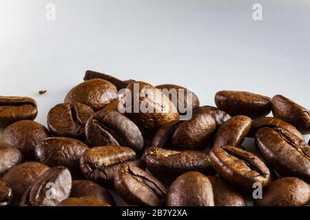 Makroaufnahme von Kaffeebohnen in einer weißen Kaffeetasse Stockfoto