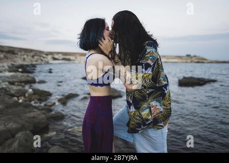 Junge Paar küssen am Strand Stockfoto