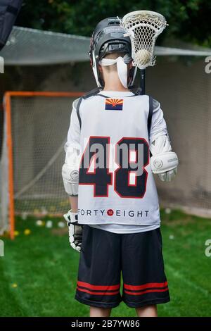 Ein Teenager posiert für Porträts in seiner Lacrosse-Uniform. Stockfoto