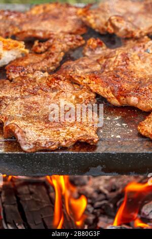 Auf einem Grillgrill aus Marmor wird rieyes Fleisch gekocht. Stockfoto
