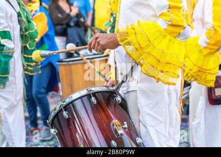 Der Schlagzeuger spielt den Rhythmus des marsches beim Karneval. Portugal Brasilien. Stockfoto