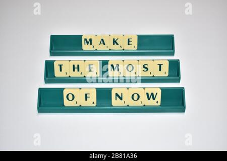 Scrabble Spielsteine machen das Beste aus. Motivationszitat Scrabble blockiert Briefe Grauer Hintergrund Lebenszitat induzieren Alphabet. Stockfoto