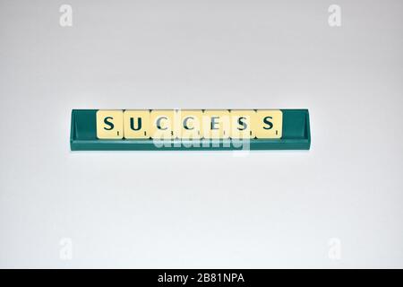 Scrabble Kacheln schreiben Erfolg Motivationszitat Scrabble Blocks Letters Grey Background Life Quote induzieren Alphabet. Stockfoto