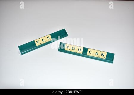 Scrabble Kacheln buchstabieren Ja Sie können motivierendes Zitat Scrabble Blocks Letters Grauer Hintergrund Lebenszitat induzieren Alphabet. Stockfoto