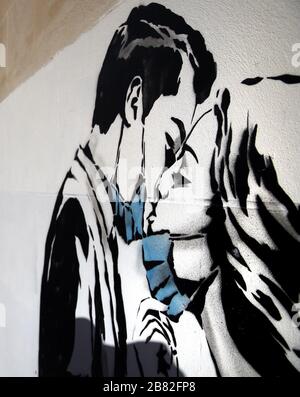 Ein Kunstwerk des Künstlers, bekannt als Rebel Bear, ist an einer Wand in der Bank Street in Glasgow aufgetaucht. Die neue Ergänzung zu Glasgows Straßenkunst erfasst die globale Coronavirus Krise. Das Stück zeigt eine Frau und einen Mann, der sich zurückzieht, um sich gegenseitig einen Kuss zu geben. Stockfoto