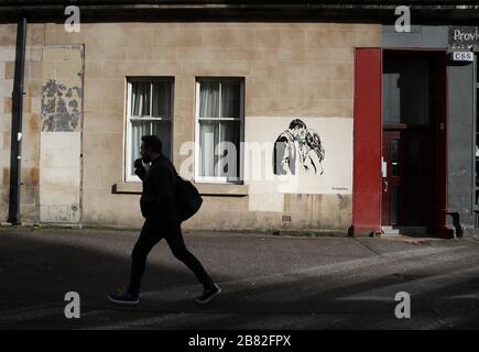 Ein Kunstwerk des Künstlers, bekannt als Rebel Bear, ist an einer Wand in der Bank Street in Glasgow aufgetaucht. Die neue Ergänzung zu Glasgows Straßenkunst erfasst die globale Coronavirus Krise. Das Stück zeigt eine Frau und einen Mann, der sich zurückzieht, um sich gegenseitig einen Kuss zu geben. Stockfoto