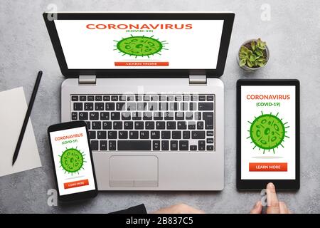 Coronavirus, Kovid-19-Konzept auf Laptop, Tablet und Smartphone-Bildschirm über grauem Tisch. Soziale Distanzierung. Flaches Lay Stockfoto