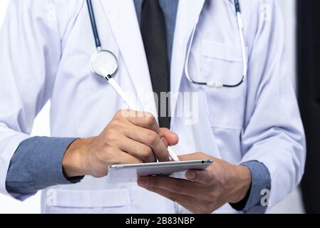 Ärzte verwenden Tabletten, um Behandlungsergebnisse zu analysieren und medizinische Wissenschaft zu studieren. Stockfoto