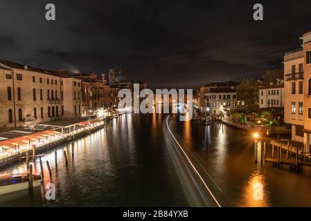 Blick auf den Canal Grande bei Nacht, vorbeifahrende Boote, Venedig/Italien Stockfoto