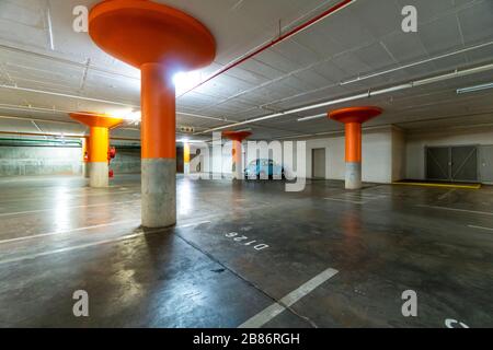 Blauer Oldtimer auf einem leeren, dunklen Parkplatz in der Tiefgarage Stockfoto