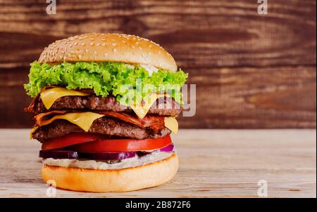 Appetitlicher Burger auf Holzgrund Stockfoto