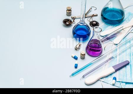 Laboruntersuchungen von Coronavirus. Weltweite Pandemie COVID-19, 2019-nCoV, SARS-COV-2. Medizinische Kolben, Reagenzgläser, Antikörpertest, Pillen, Pulver. Leicht Stockfoto