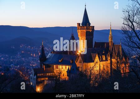 Das alte Schloss in Wernigerode am Abend mit dem Harz im Hintergrund Stockfoto