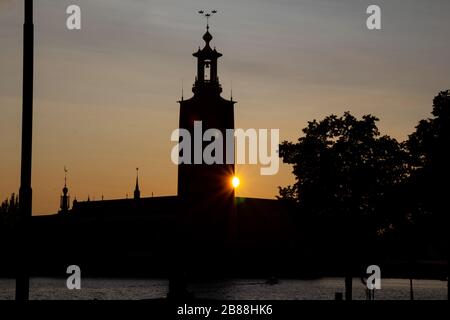 Direkt hinter dem Rathaus von Stockholm ist ein Sonnenschein zu sehen, wenn die Sonne an einem warmen Sommerabend in der Hauptstadt Schwedens untergeht. Es gibt ein ruhiges Gefühl. Stockfoto