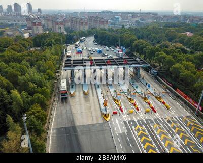 Peking, China. März 2020. Das Luftbild vom 17. März 2020 zeigt gecharterte Busse mit Wanderarbeitern, die eine Mautstation in Xiaogan, der zentralchinesischen Provinz Hubei, passieren. Credit: Hu Huhu/Xinhua/Alamy Live News Stockfoto