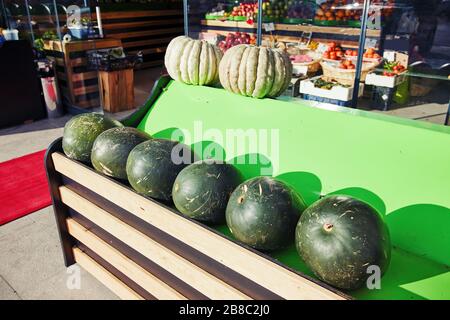 Frische Wassermelonen und Kürbisse auf dem Außenstall eines Lebensmittelgeschäfts Stockfoto