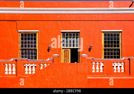 Weiße Details auf Block orange, ergänzt durch ein Trio von verglasten Fenstern. Alles in perfekter Balance in 79 Wale Street, Bo-Kaap. Stockfoto