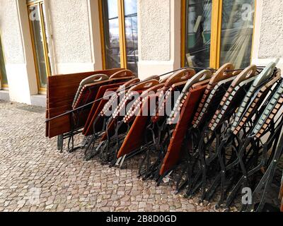 Zusammengeklappte Gartenstühle und Tische aus einem Restaurant im angesagten Berliner Bezirk Friedrichshain während der Abschaltung des Coronavirus in Deutschland. Stockfoto