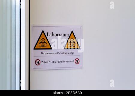 Schild "Bio Hazard" an einer Tür eines Labors - Coronavirus Test. (Deutscher Text auf dem Schild: Laborraum, nur mit Schutzklirrung eingeben, Beware Stockfoto