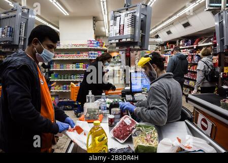 Le Charcutier, Beirut, Libanon. März 2020. Die Mitarbeiter der Supermarkt-Kasse tragen Vollgesicht- und Handschuhe, wenn sie die Einkäufe der Käufer überprüfen. Credit: Elizabeth Fitt/Alamy Live News Stockfoto