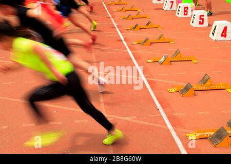 Der Start in der Sportversammlung beginnen die Athleten zu laufen Stockfoto