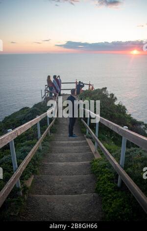 Die Menschen versammeln sich am Muir Beach mit Blick auf Marin County, Kalifornien, um den Sonnenuntergang zu beobachten. Stockfoto