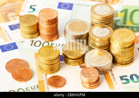 Stapel von Euro-Münzen auf Euro-Banknoten, für Hintergründe. Deutschland Stockfoto